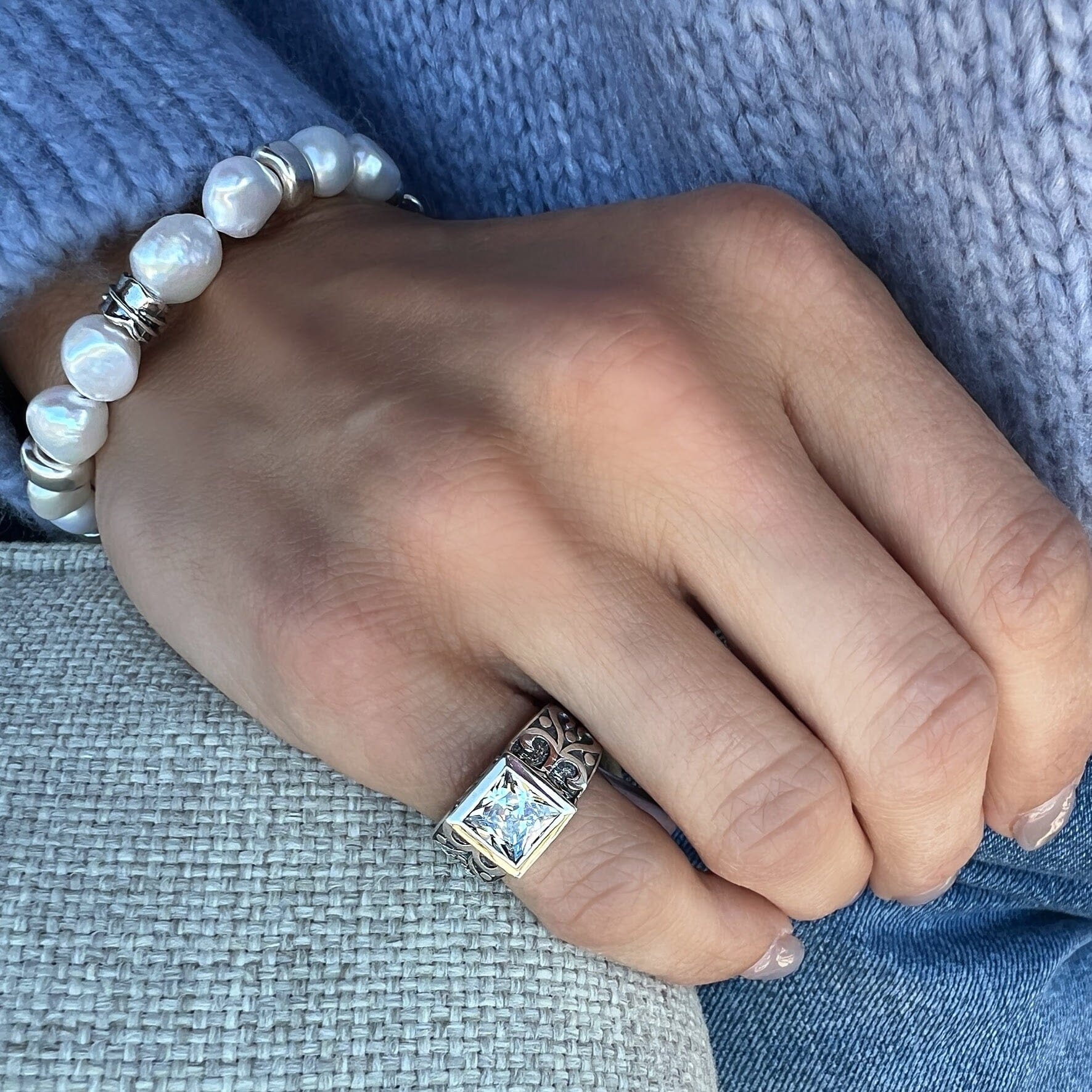 chunky pinky ring with intricate silver details and priness cut cz