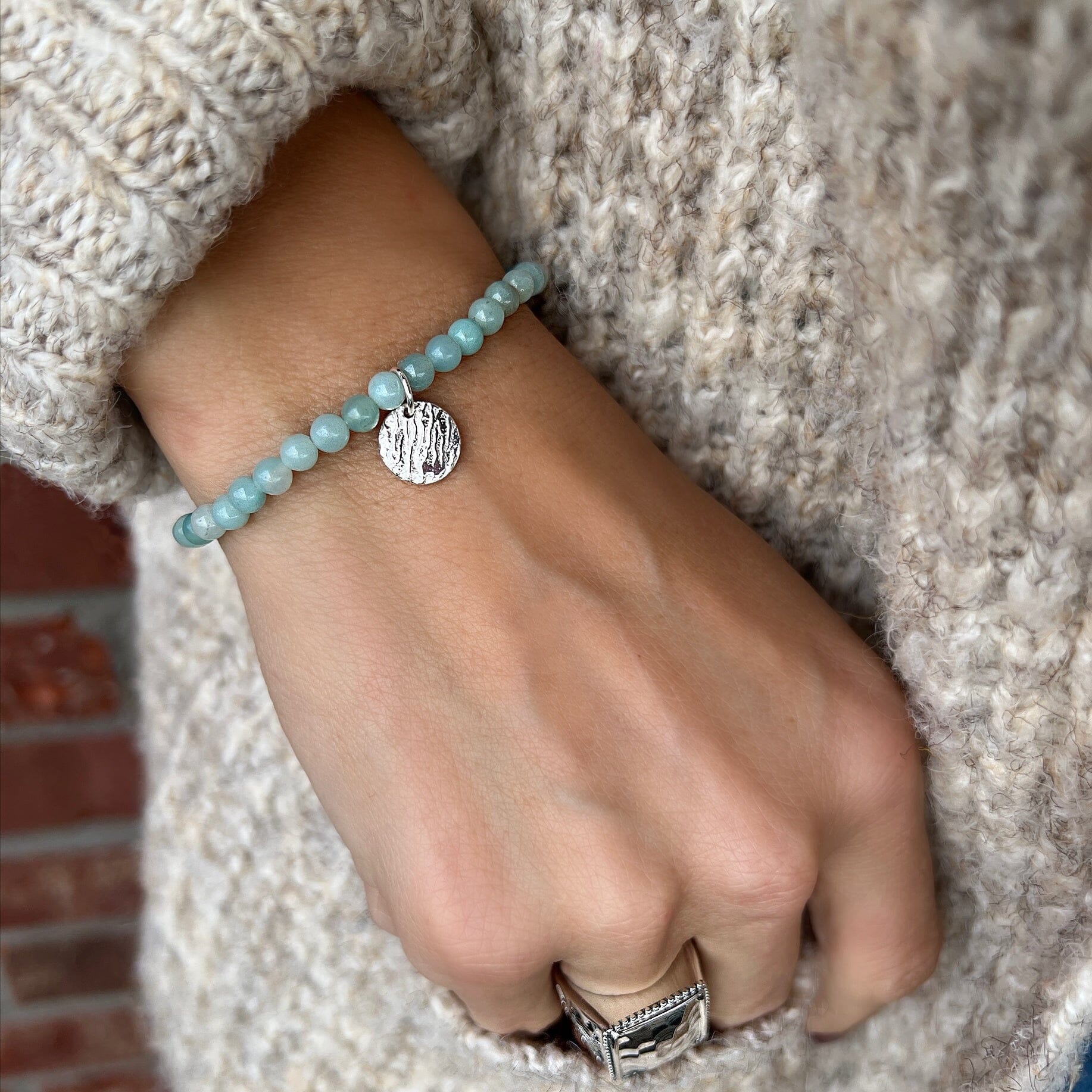 beach style stretch bracelet featuring amazonite beads and a silver hammered disk