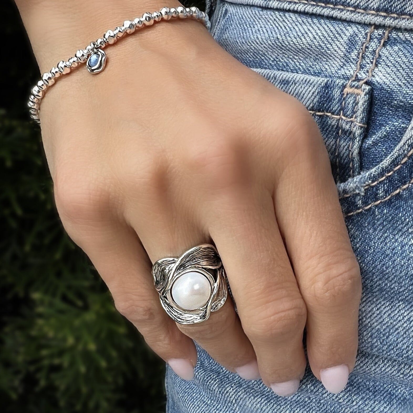 wide silver ring featuring a large freshwater pearl center