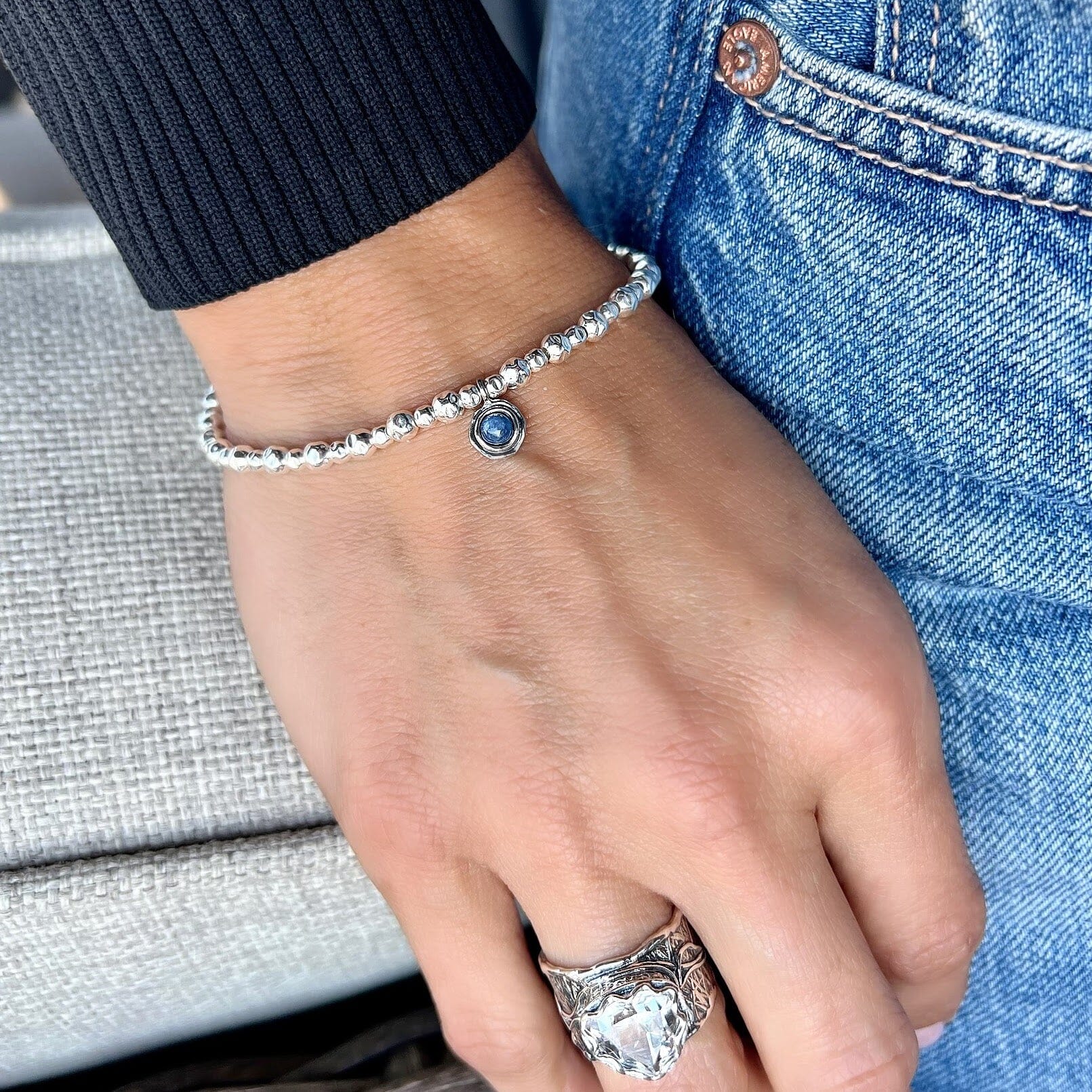 slightly hammered silver beaded bracelet featuring round blue kyanite