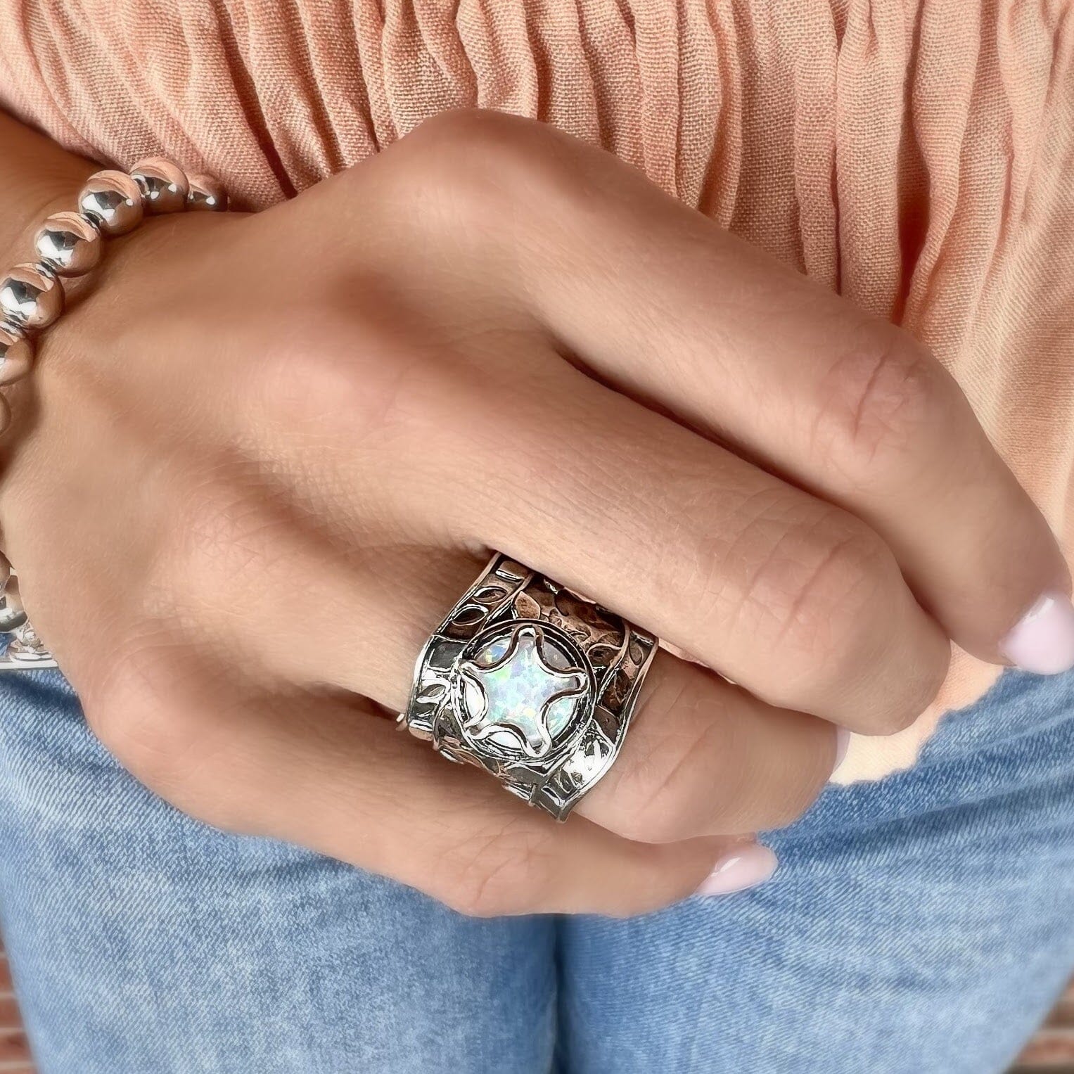 chunky silver designer ring featuring reconstructed white opal