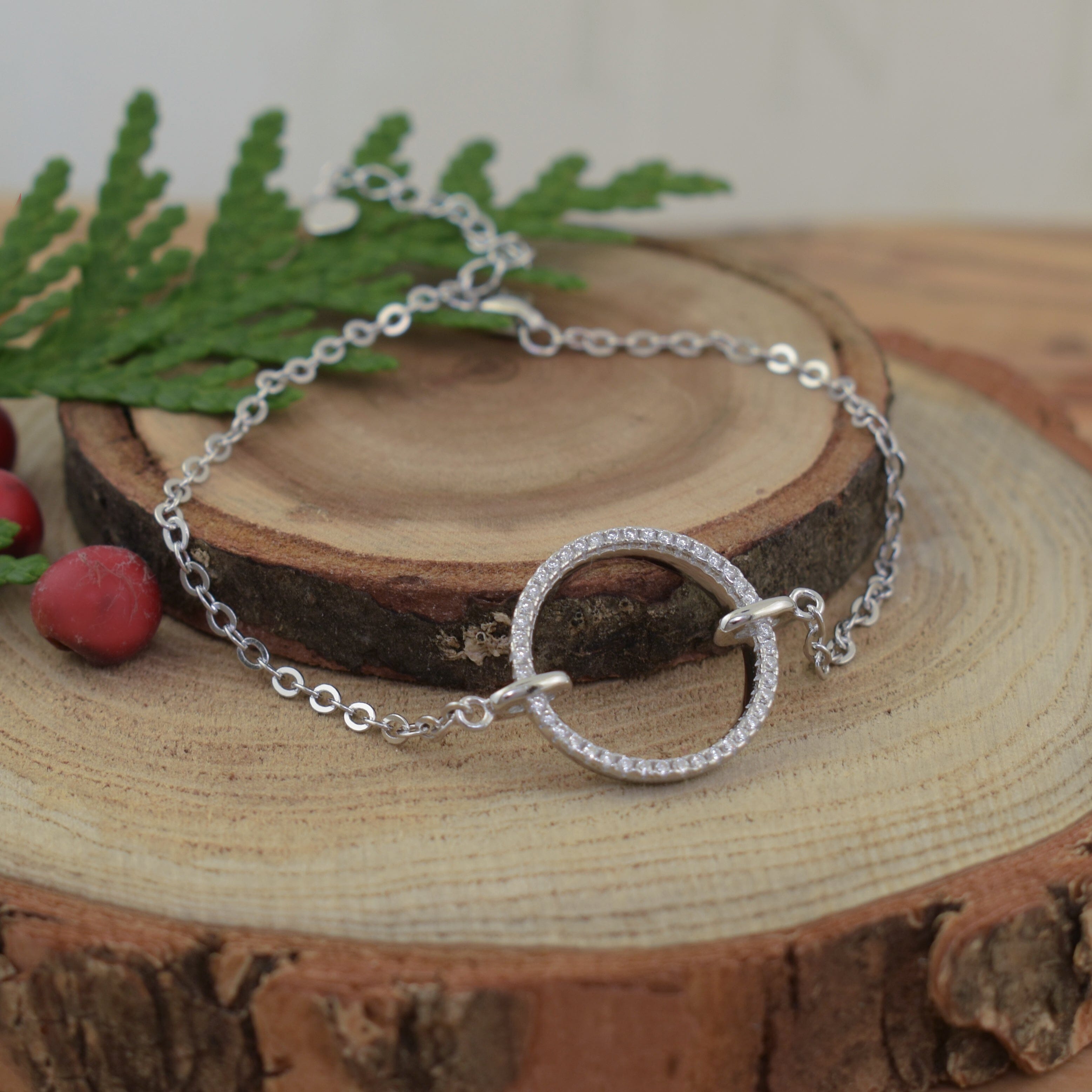 minimalist silver bracelet featuring a circular pendant with pave-set CZs