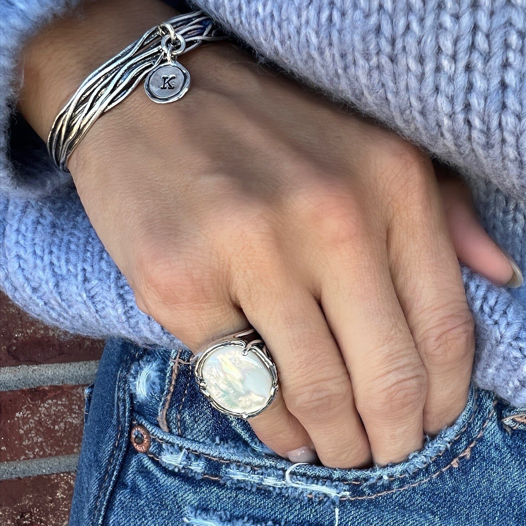 chunky mother of pearl pinky ring with silver wave details