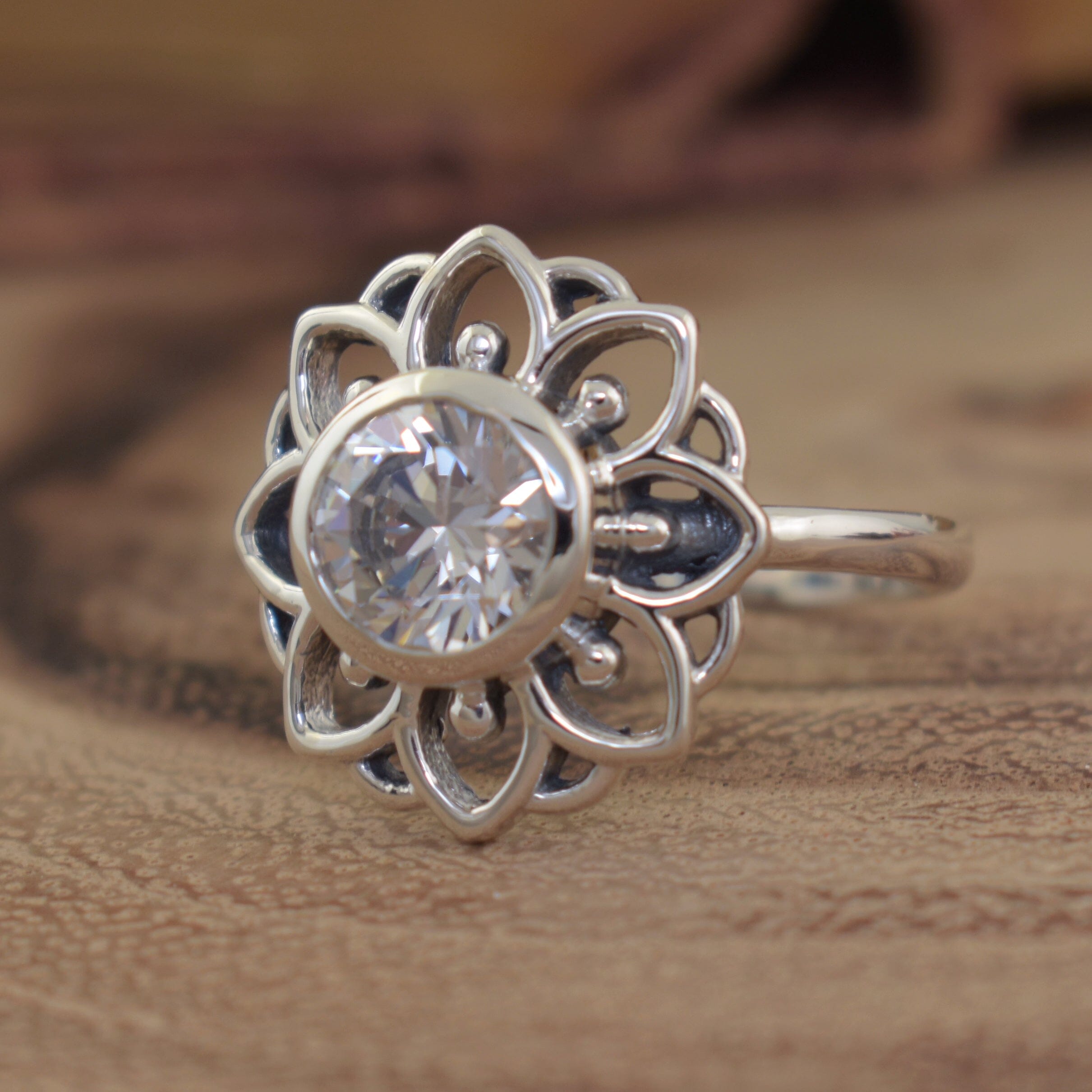 silver flower ring with a clear cz center