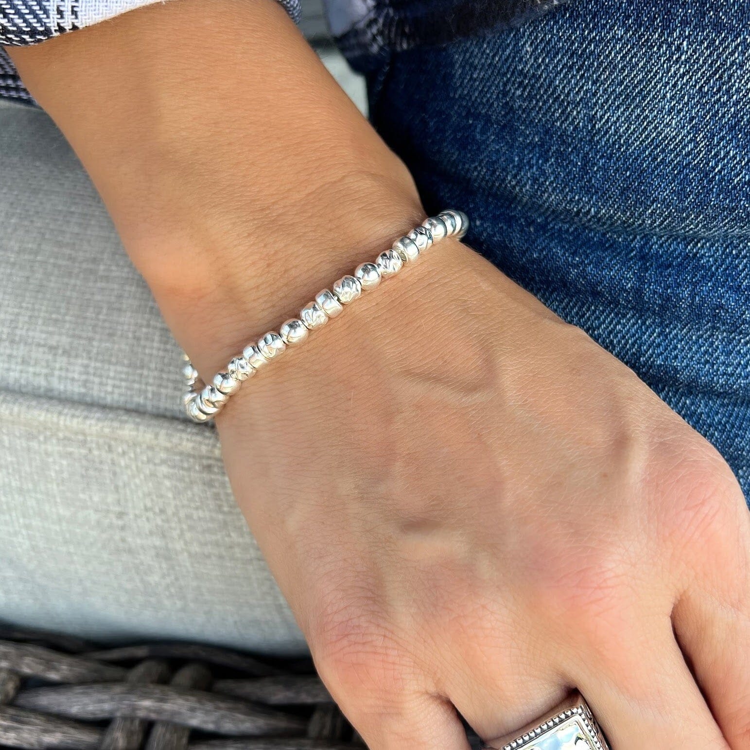 designer sterling silver bracelet featuring slightly hammered beads