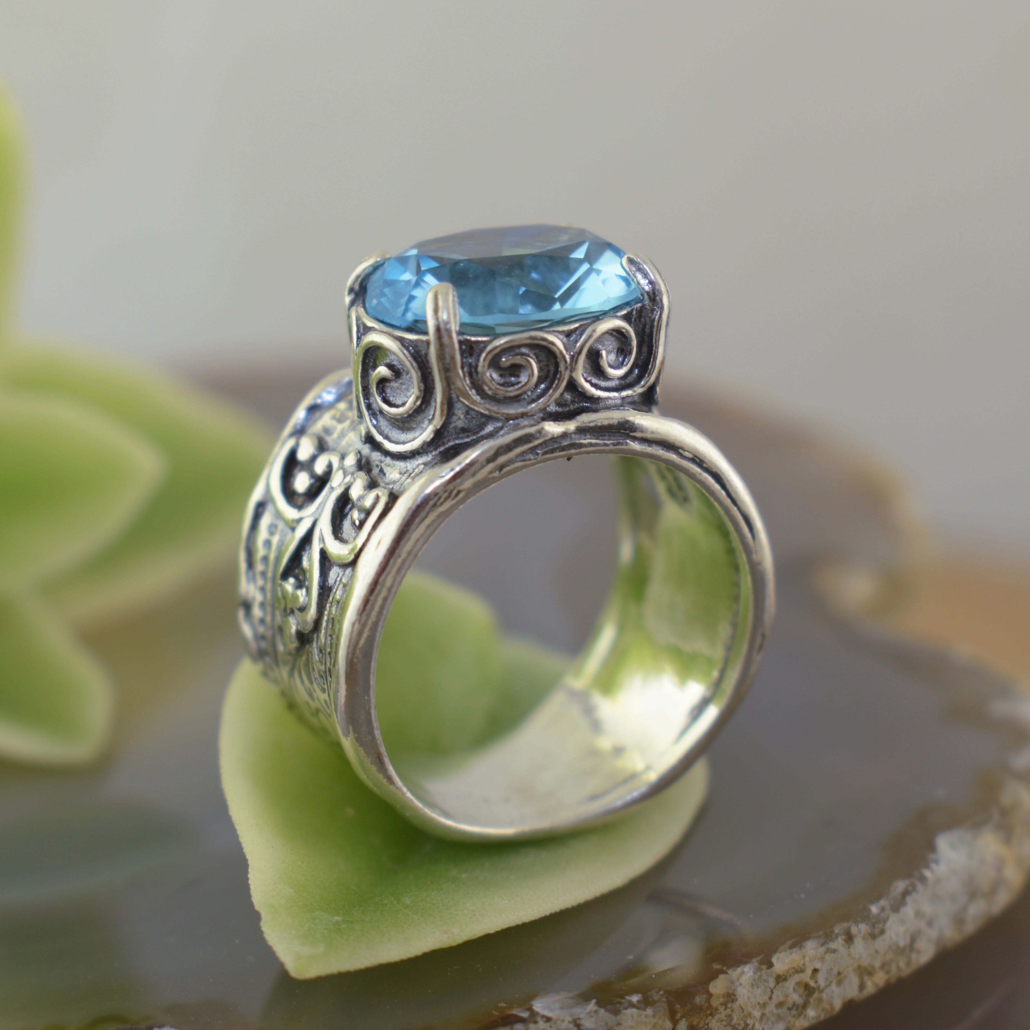 Designer inspired sterling silver ring with oval shaped aqua cubic zirconia