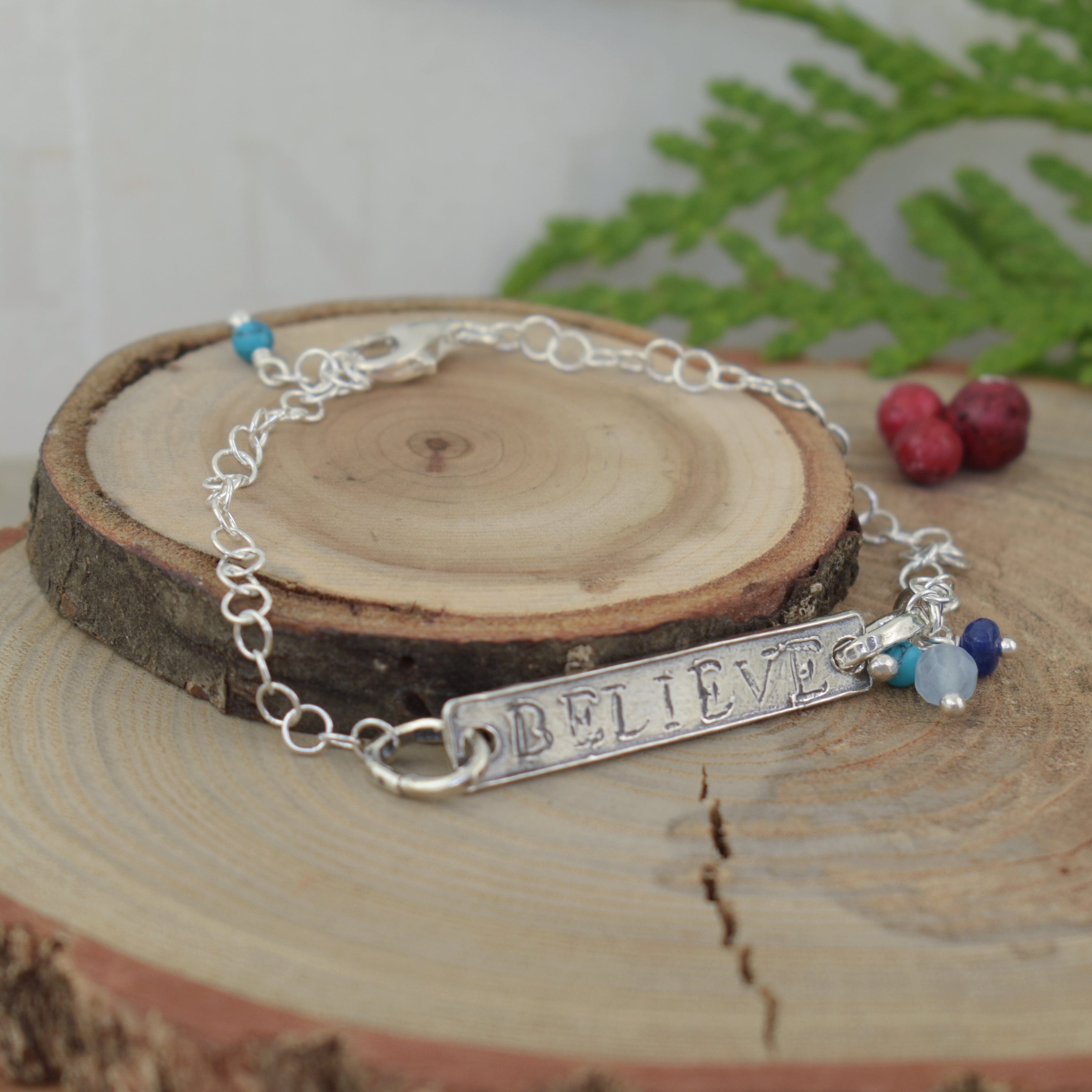 Believe bar bracelet featuring Lapis, Reconstructed Turquoise, and Blue Quartz gemstone dangles