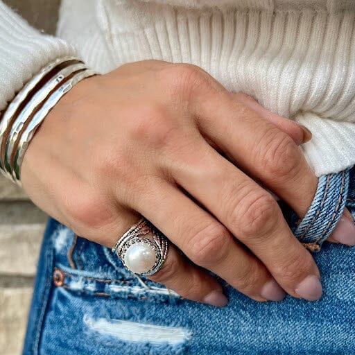 chunky pinky ring featuring a large freshwater pearl set in crown-like prongs