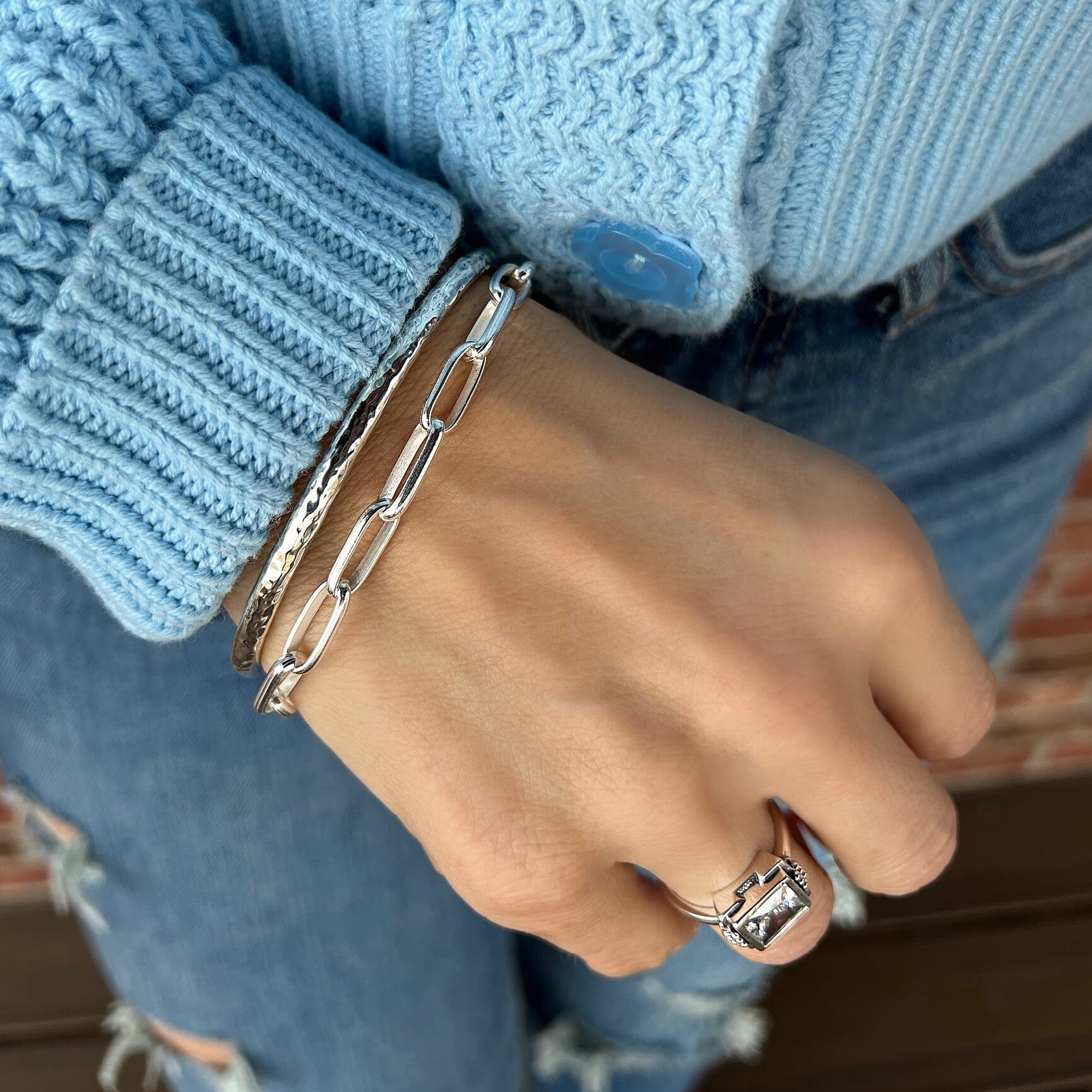 minimalist oval link bracelet in sterling silver paired with a thin silver bangle