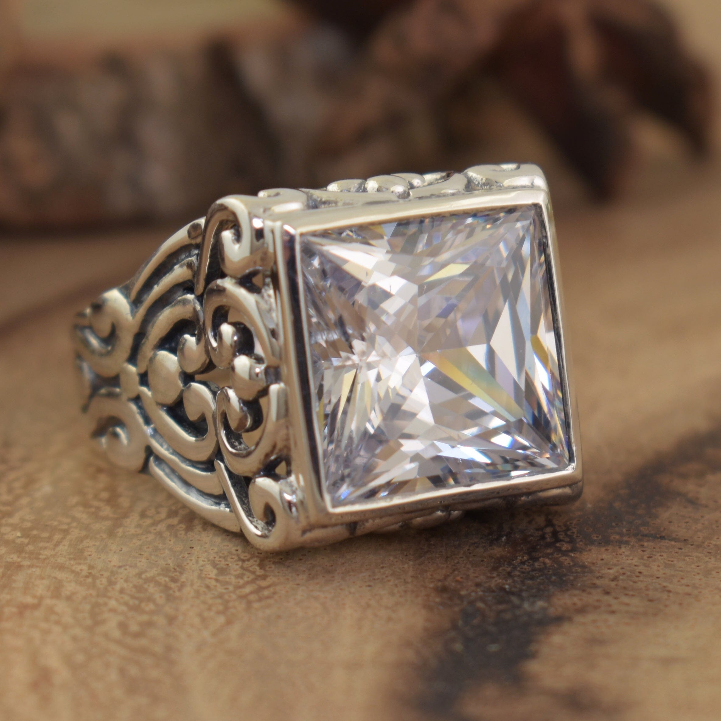 chunky silver designer ring bezel set with princess cut cubic zirconia