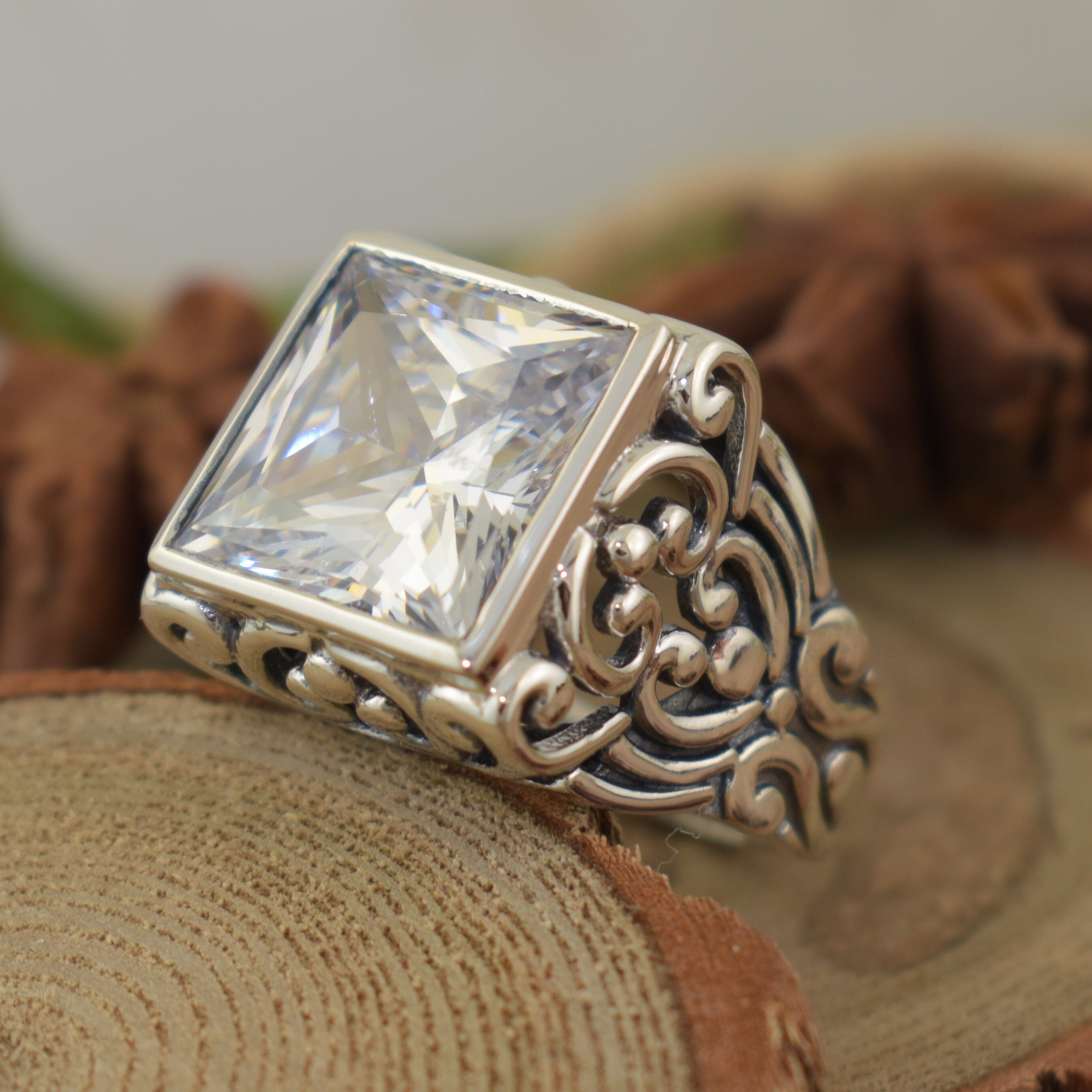 princess cut cz bezel-set in filigree swirl sterling silver band