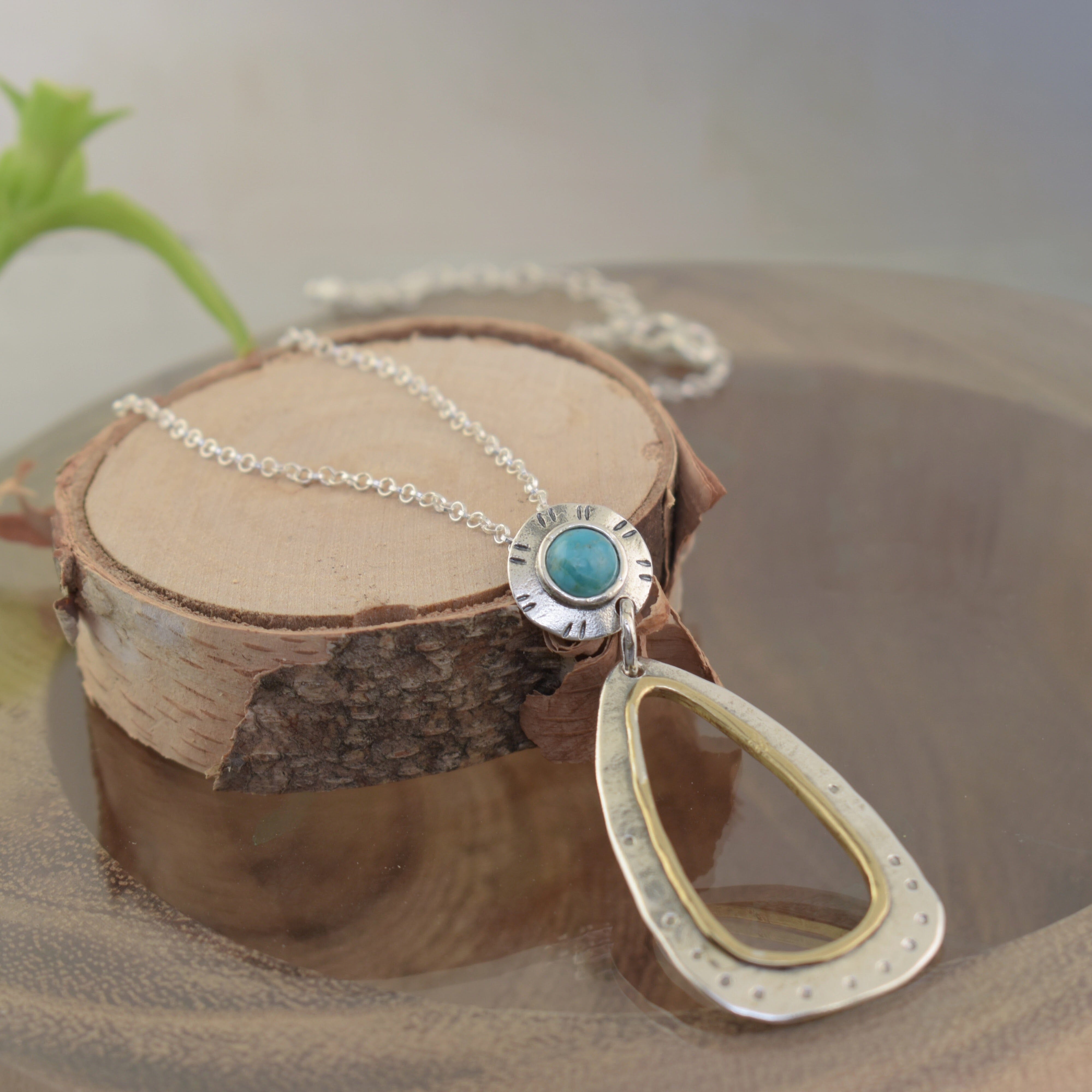 .925 sterling silver and brass necklace featuring round turquoise stone