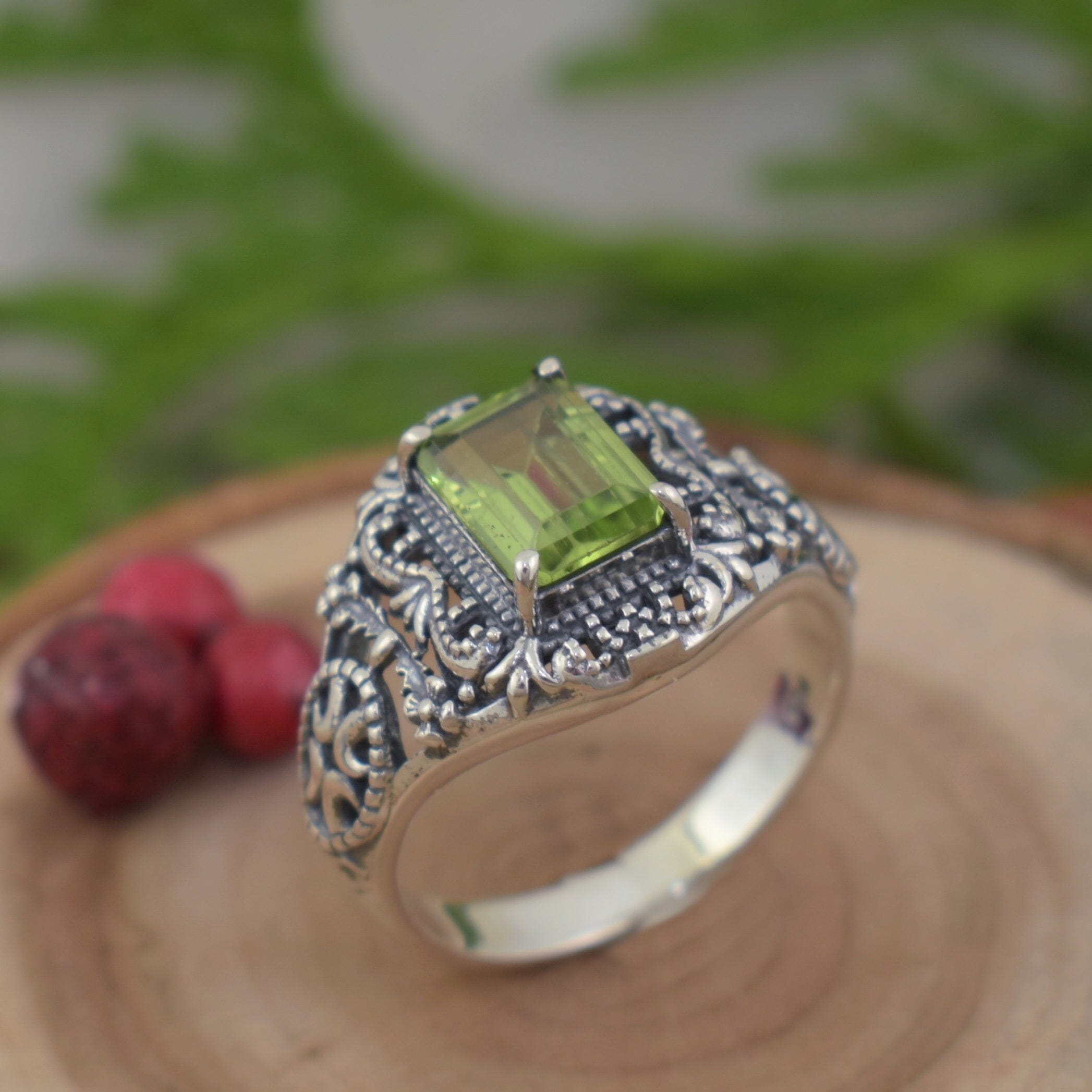 Designer sterling silver vintage-inspired ring featuring natural emerald cut peridot