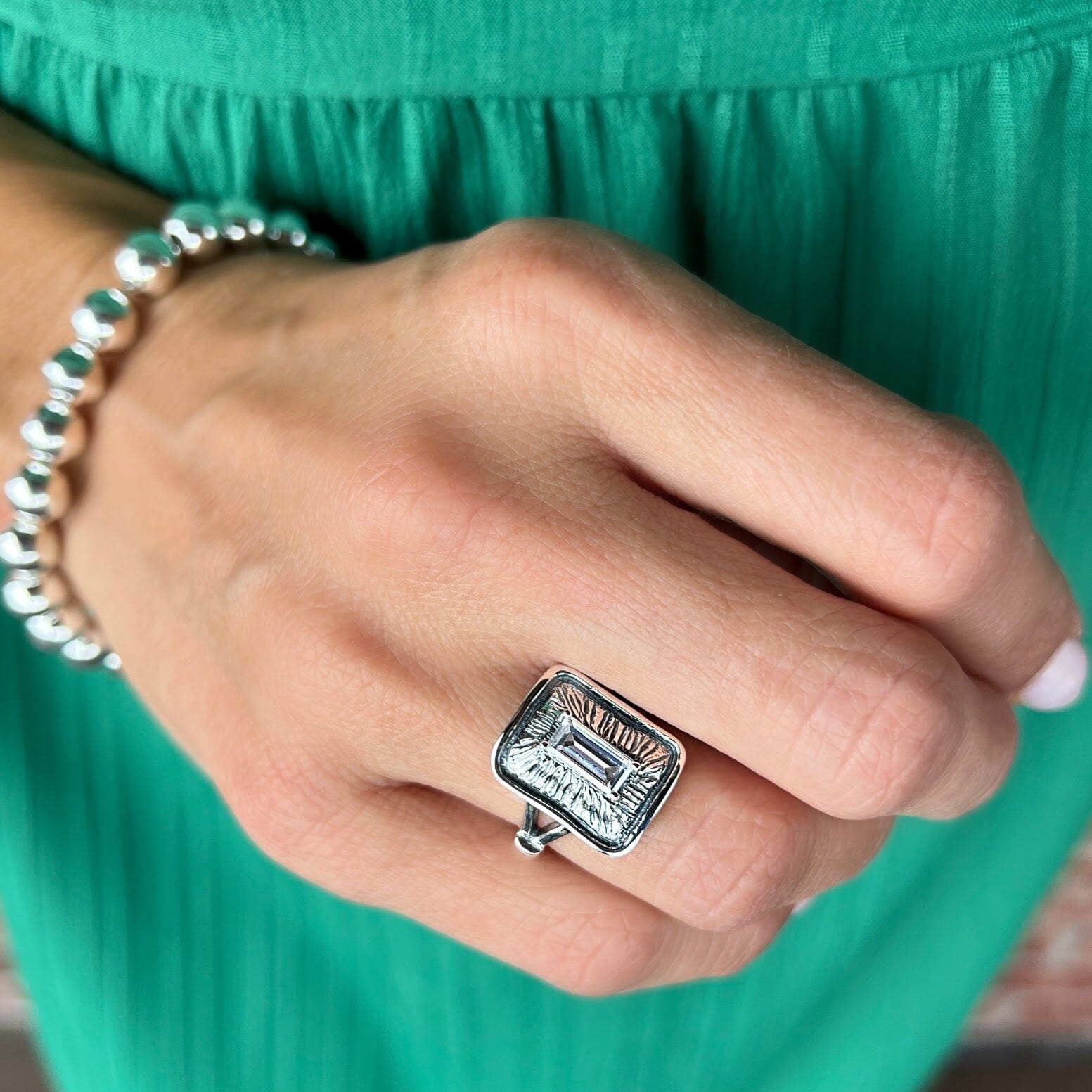 chunky rectangular silver ring featuring an emerald cut cz center