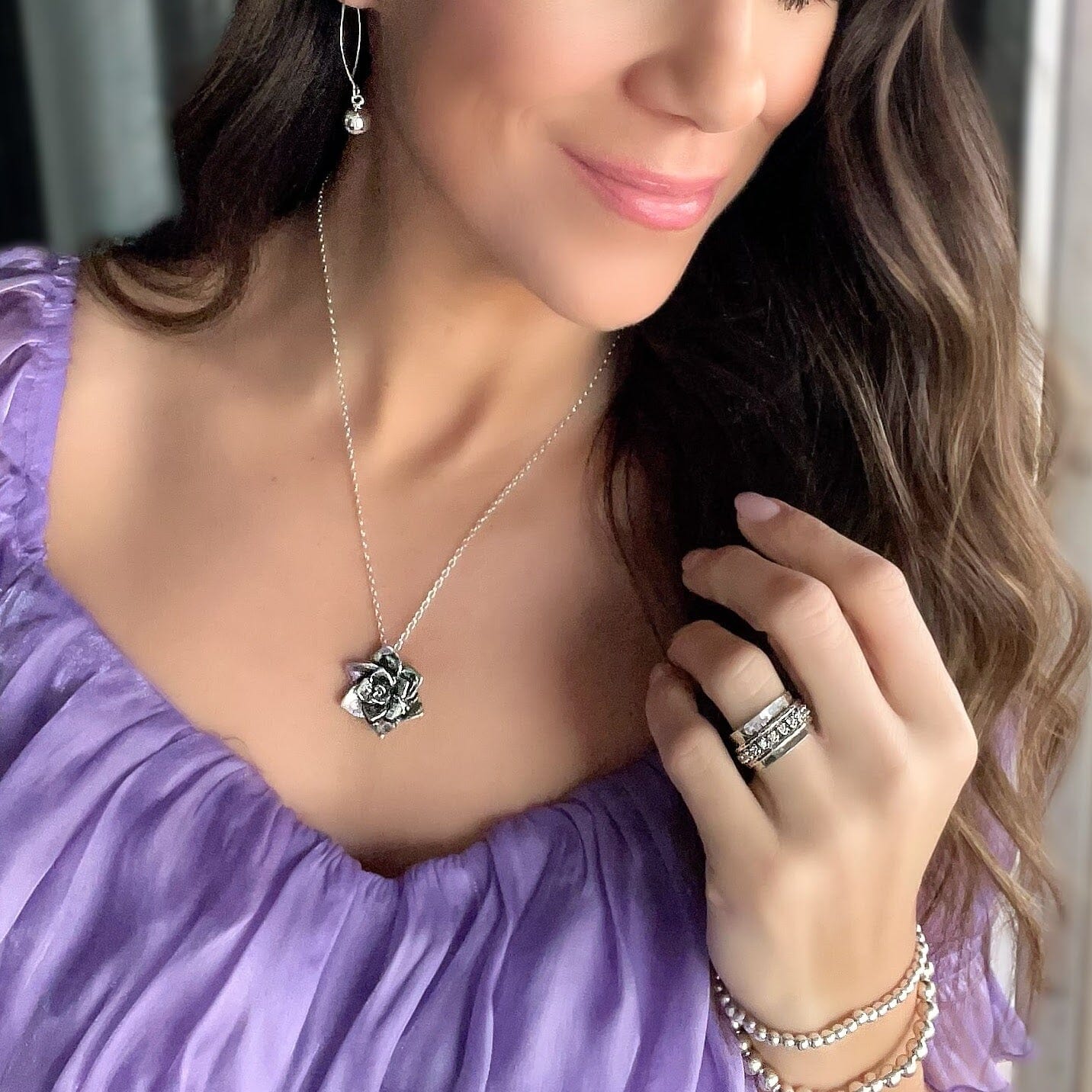 Rose Necklace paired with Roundabout Earrings, Primitive Shine Ring in silver, and the Beaded Stack Bracelets