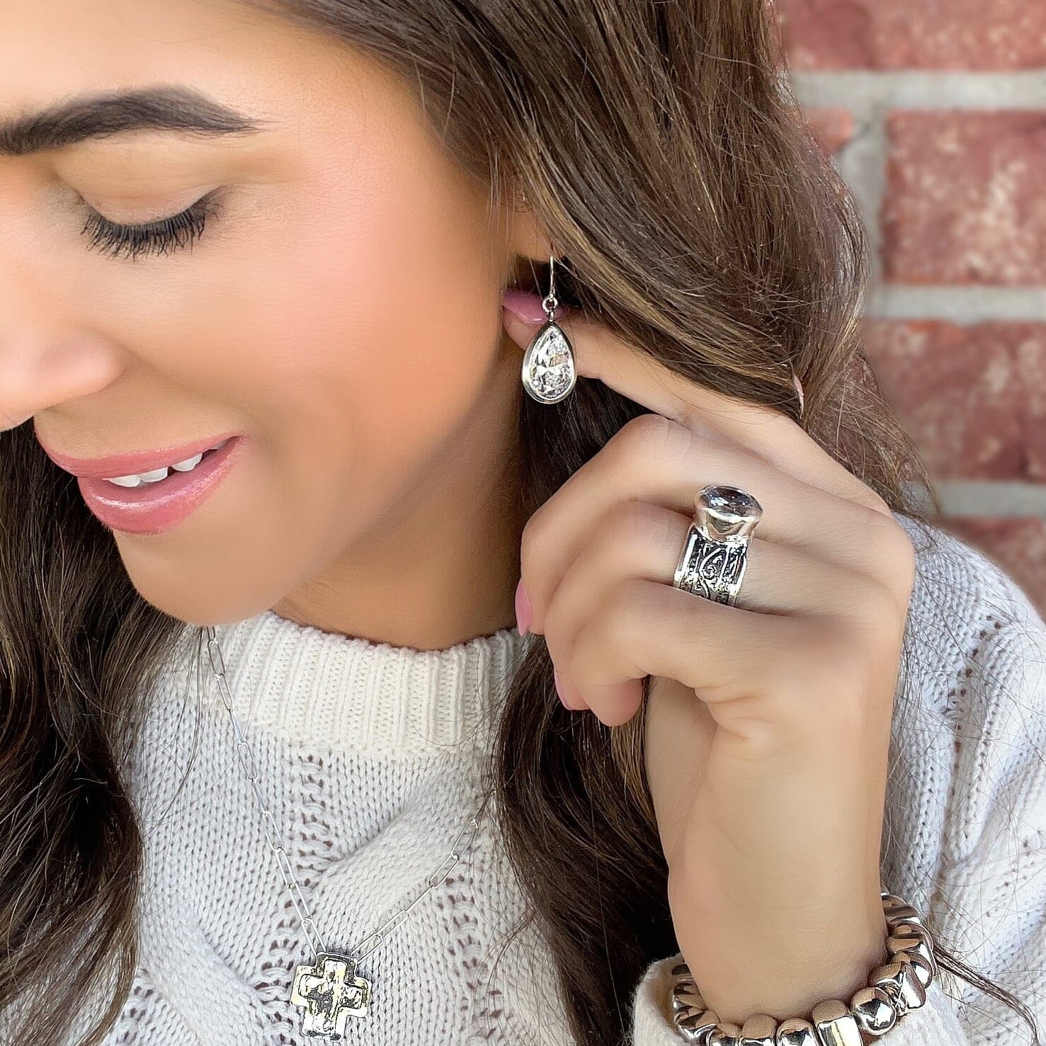 silver Lavish Tears Earrings paired with The Ritz Ring, Santa Fe Cross Necklace, and Roundabout Bracelet