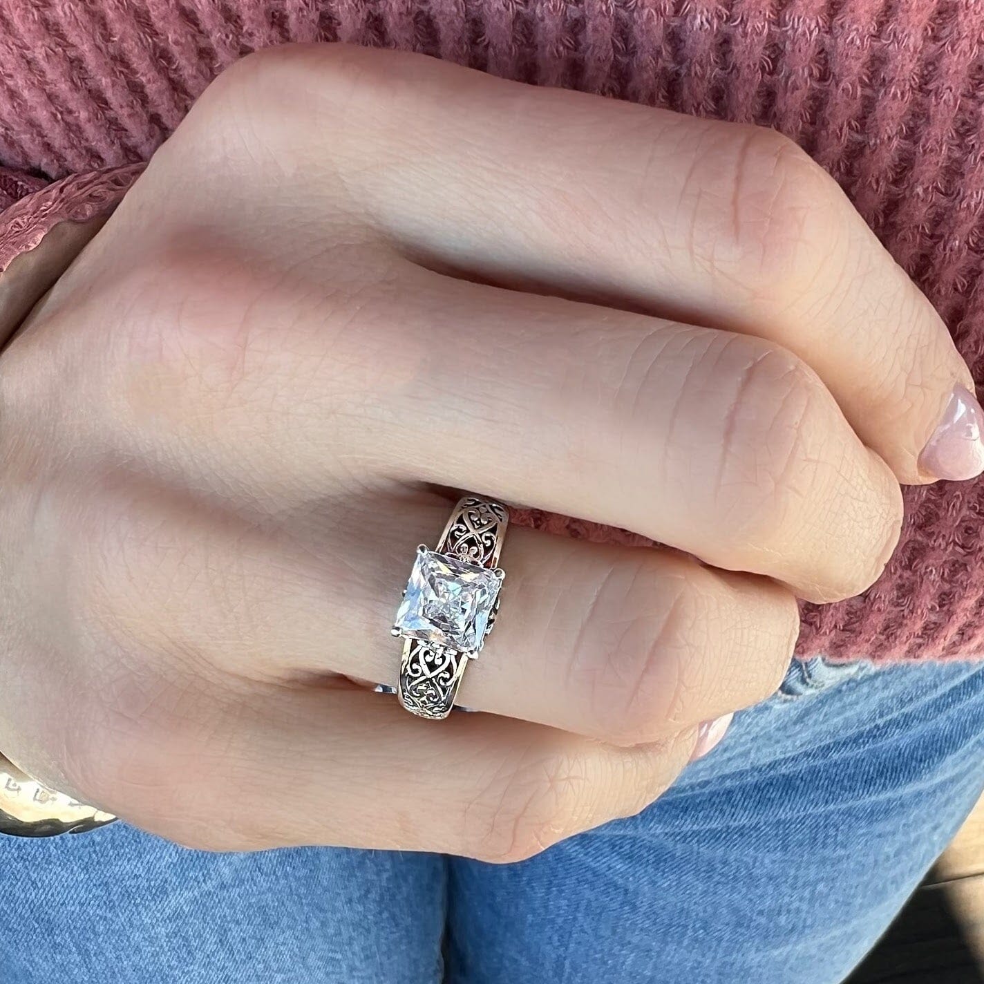 princess cut silver ring with cut out swirls on the band