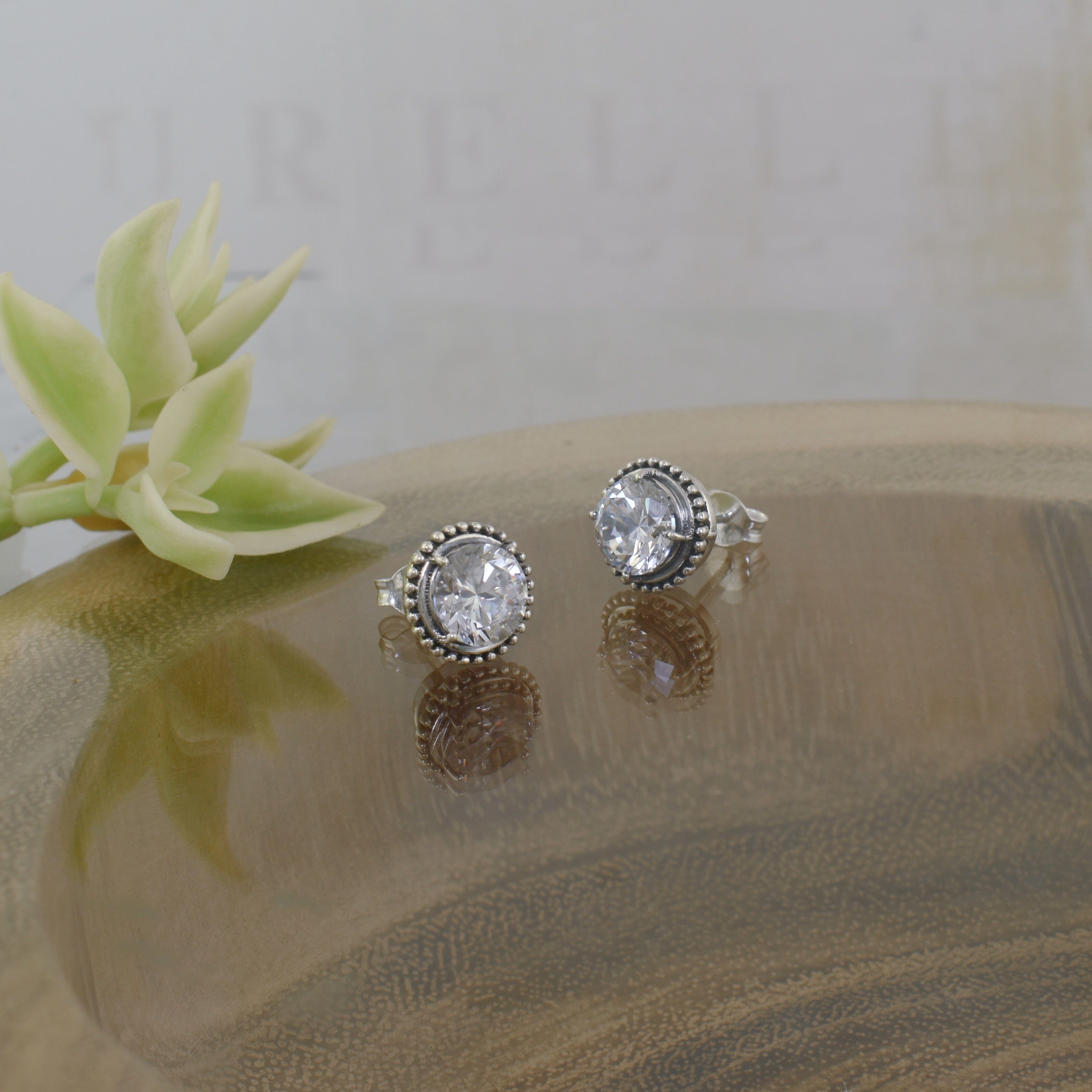 round prong-set cz earrings surrounded by a beaded design