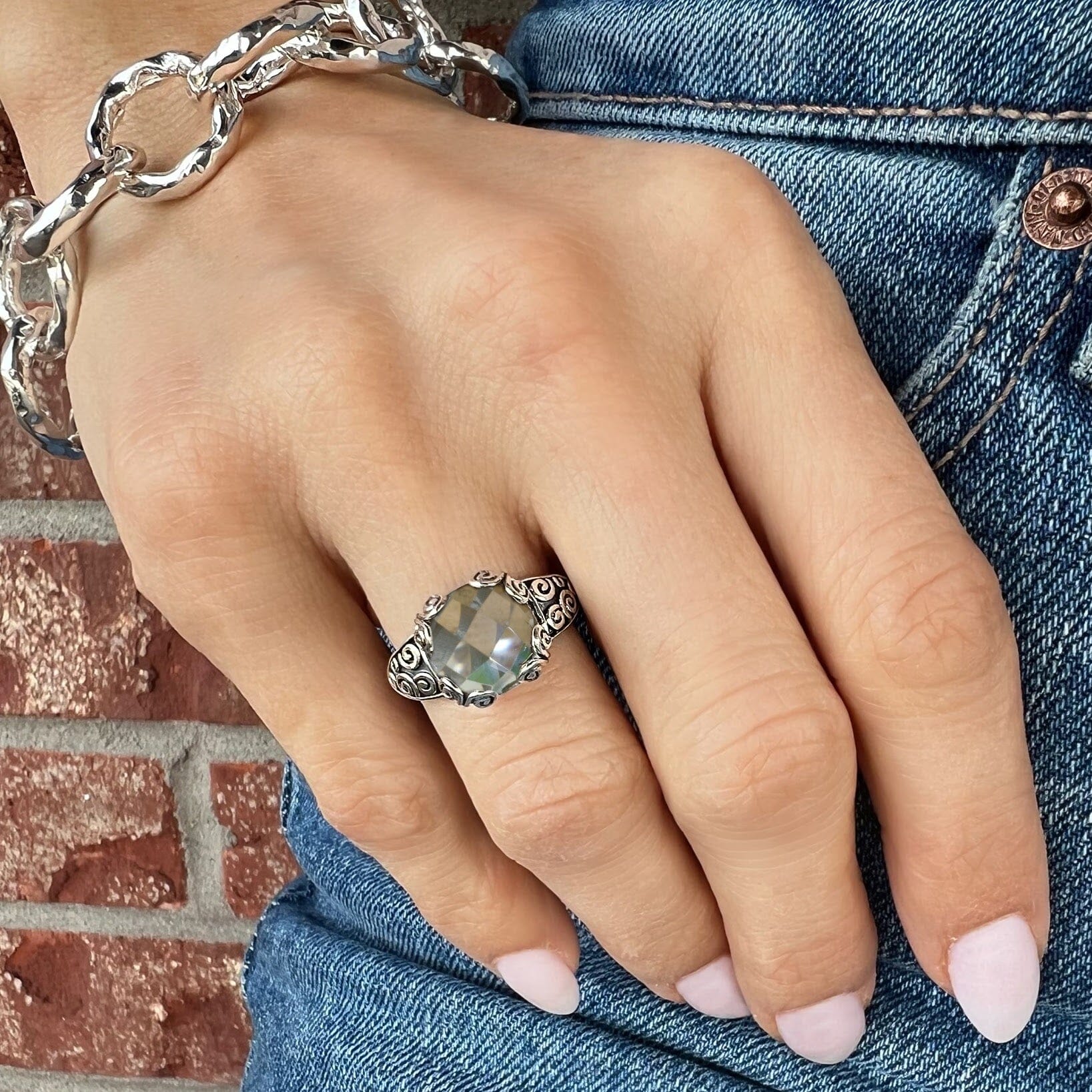 sterling silver Twirl Around Ring with a light green amethyst center stone