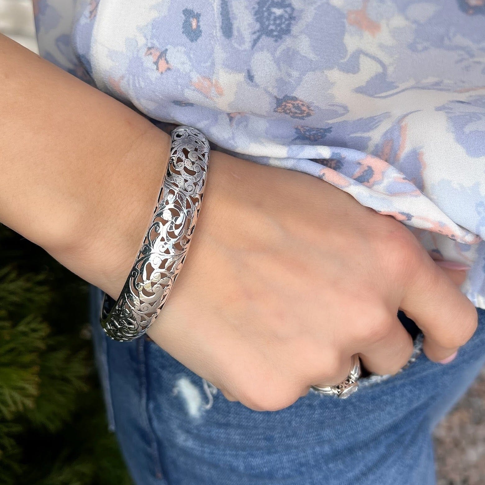 .925 sterling silver bangle with a cut-out swirl design